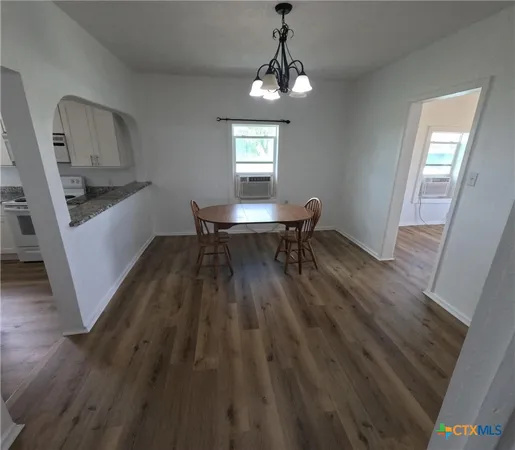 a workspace with wooden floor and a window