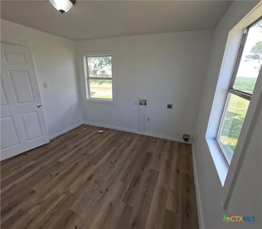 a room with wooden floor and mirror