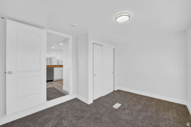 2491 Highway 89, Unit 523 Pleasant View, UT 84404 - Photo 13 of 31 Unfurnished bedroom featuring light colored carpet and a closet