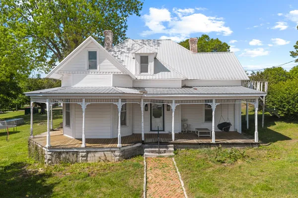 a view of a house with backyard porch and sitting area