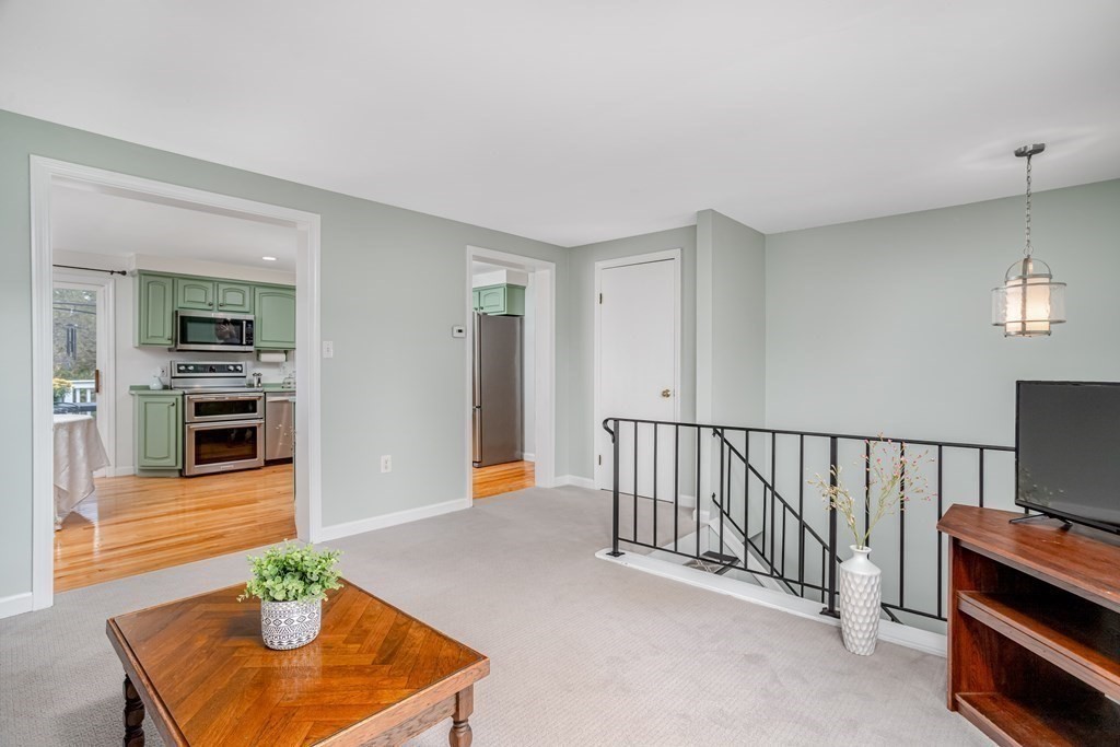 67 Bean Porridge Hill Road Westminster, MA 01473 - Photo 20 of 42 a hallway with a stove a fireplace and a workspace
