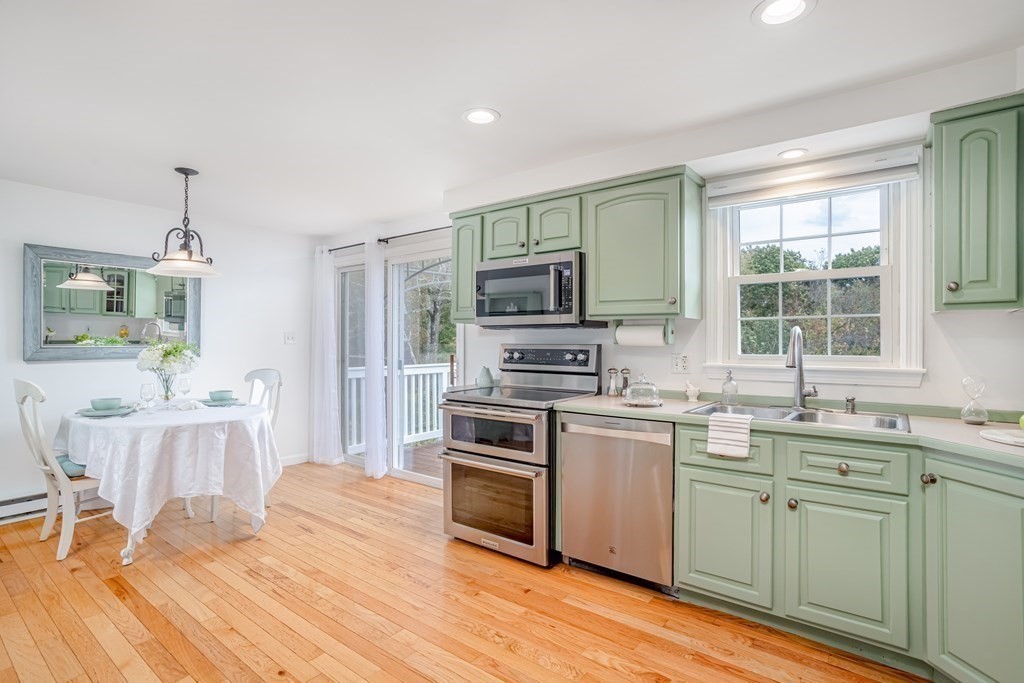 67 Bean Porridge Hill Road Westminster, MA 01473 - Photo 6 of 42 a kitchen with stainless steel appliances a stove a sink dishwasher a microwave oven and a dining table with wooden floor