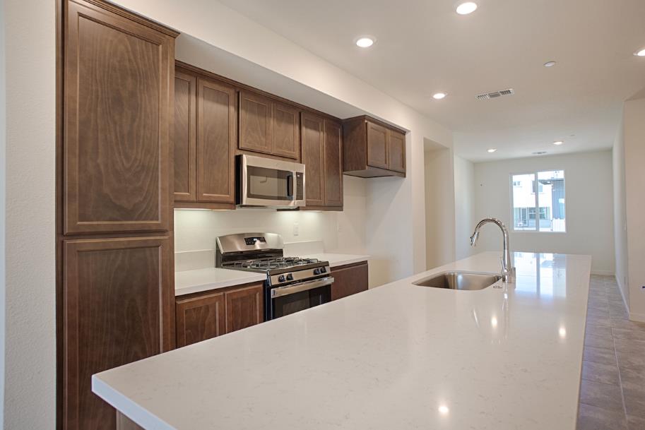 1672 17th Street Oakland, CA 94607 - Photo 11 of 24 a kitchen with stainless steel appliances a refrigerator stove microwave and sink