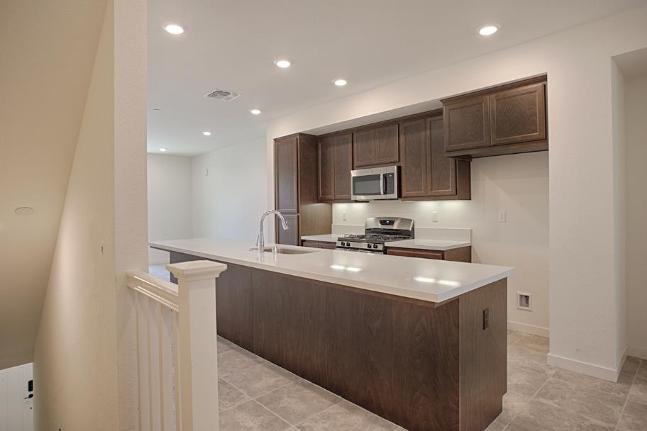 1672 17th Street Oakland, CA 94607 - Photo 12 of 24 a kitchen with stainless steel appliances granite countertop a sink stove and refrigerator