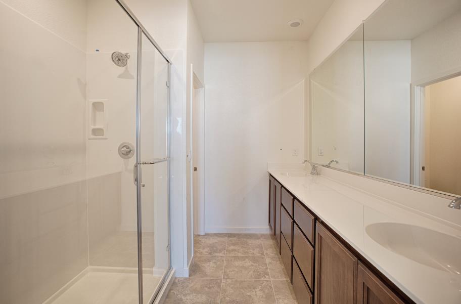 1672 17th Street Oakland, CA 94607 - Photo 21 of 24 a bathroom with a double vanity sink and mirror