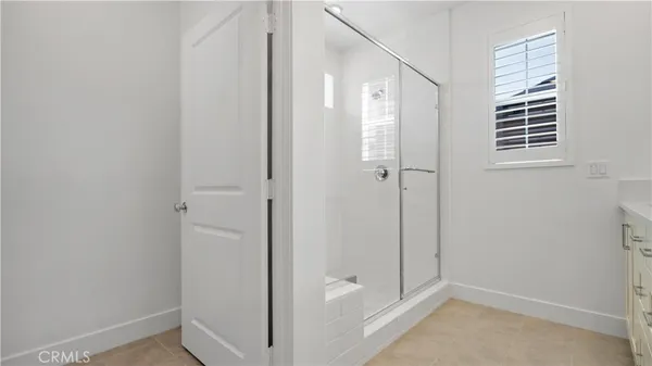 an empty room with an entryway and window