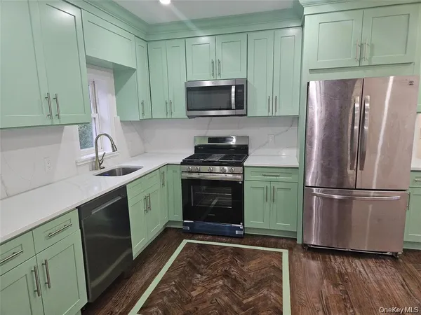 a kitchen with a refrigerator stove and sink