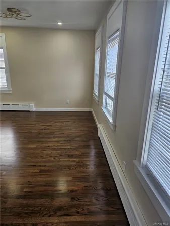 a view of a room with wooden floor and window