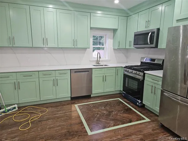 a kitchen with stainless steel appliances granite countertop a stove top oven microwave and cabinets