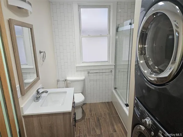 a bathroom with a sink a toilet and a mirror