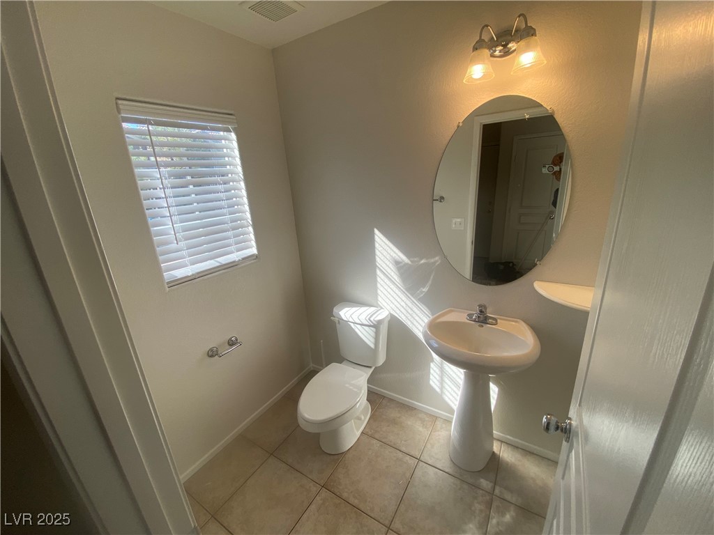578 Shewsbury Avenue Las Vegas, NV 89178 - Photo 4 of 12 Half bath with light tile patterned floors and baseboards