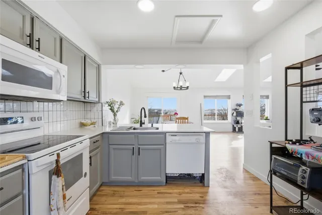 a kitchen with a sink cabinets and wooden floor