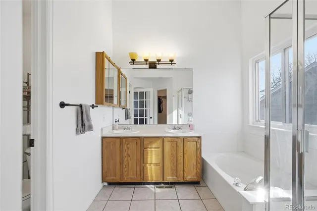 a bathroom with a tub sink and mirror