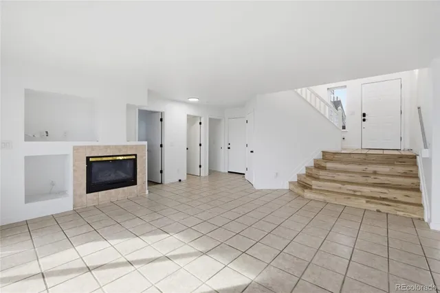 a view of a livingroom with an empty space and a fireplace