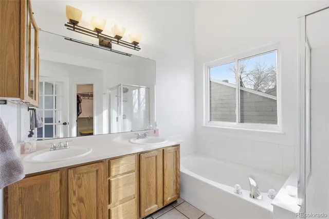 a bathroom with a tub a sink and mirror