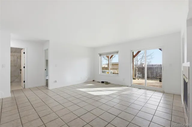 an empty room with windows and entrance