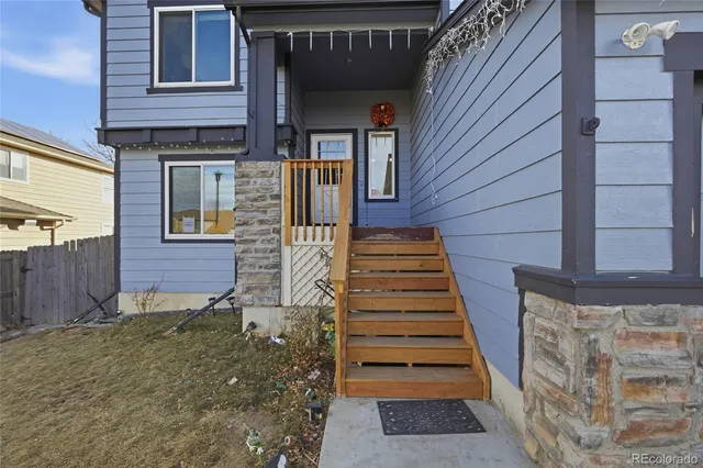a view of a house with wooden door and stairs