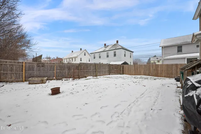a view of roof and wooden fence