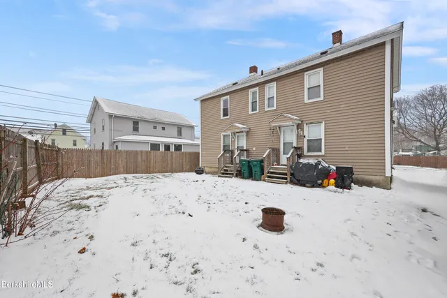 a view of a house with a snow in the background