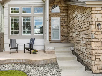 a view of front door of house with outdoor seating