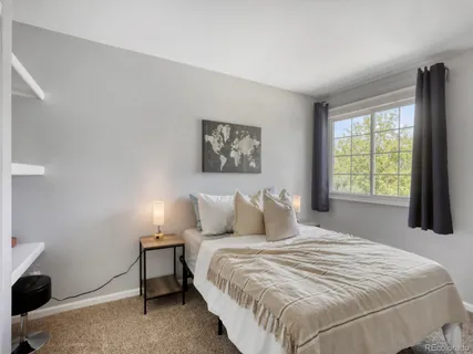 a livingroom with workspace and a window