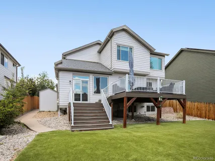 a view of a house with a yard and sitting area