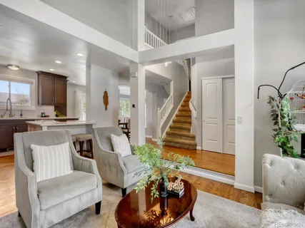 a living room with furniture and potted plants