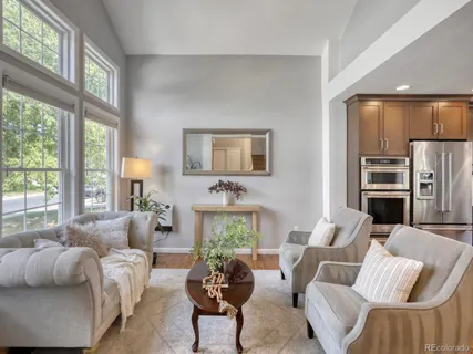 a living room with furniture fireplace and a large window