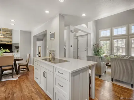 a kitchen with kitchen island granite countertop a sink stainless steel appliances and cabinets