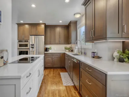a kitchen with cabinets stainless steel appliances and a window