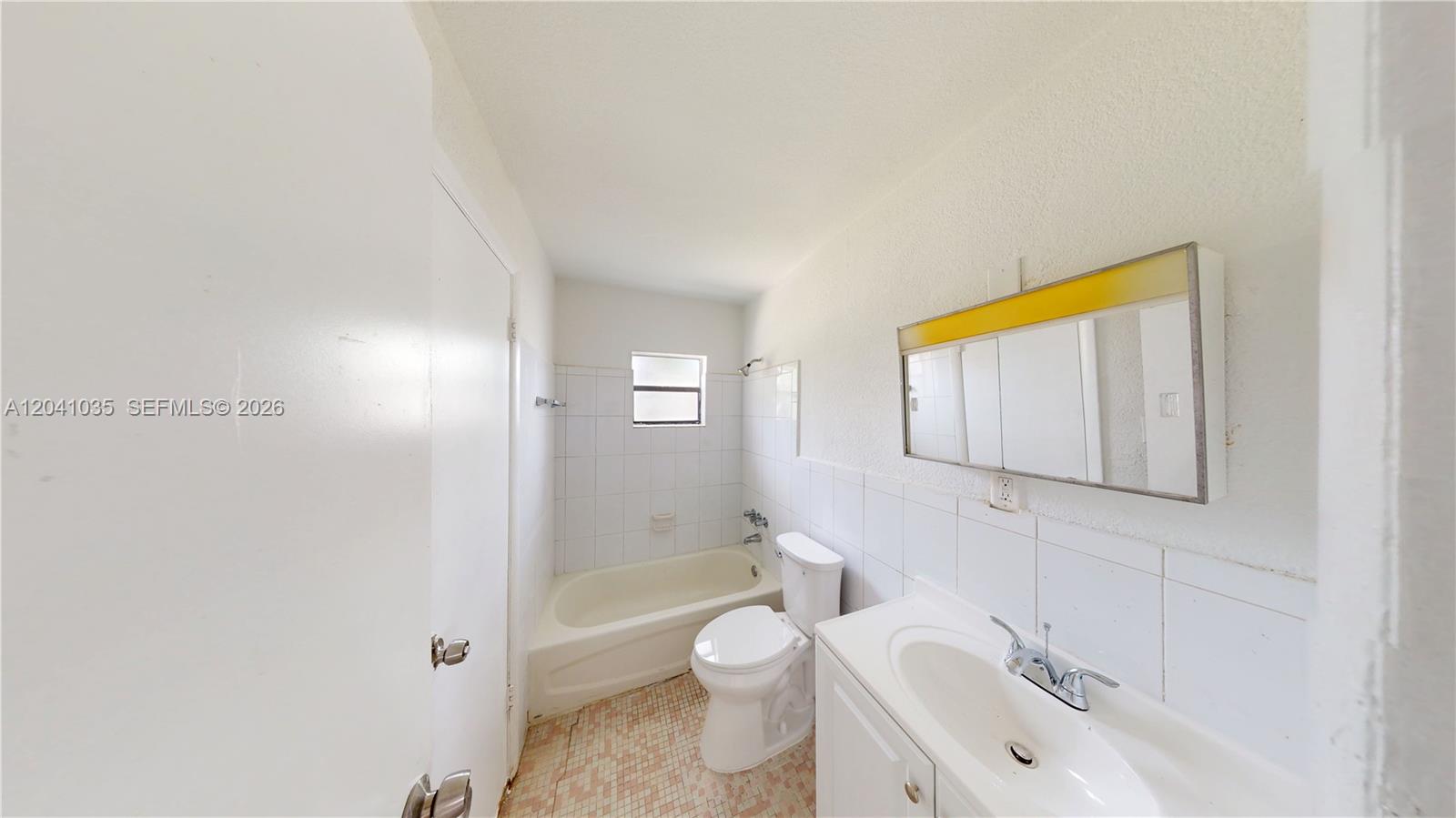 6811 Southwest 16th Street Miami, FL 33144 - Photo 16 of 21 a bathroom with a toilet sink vanity tub and shower