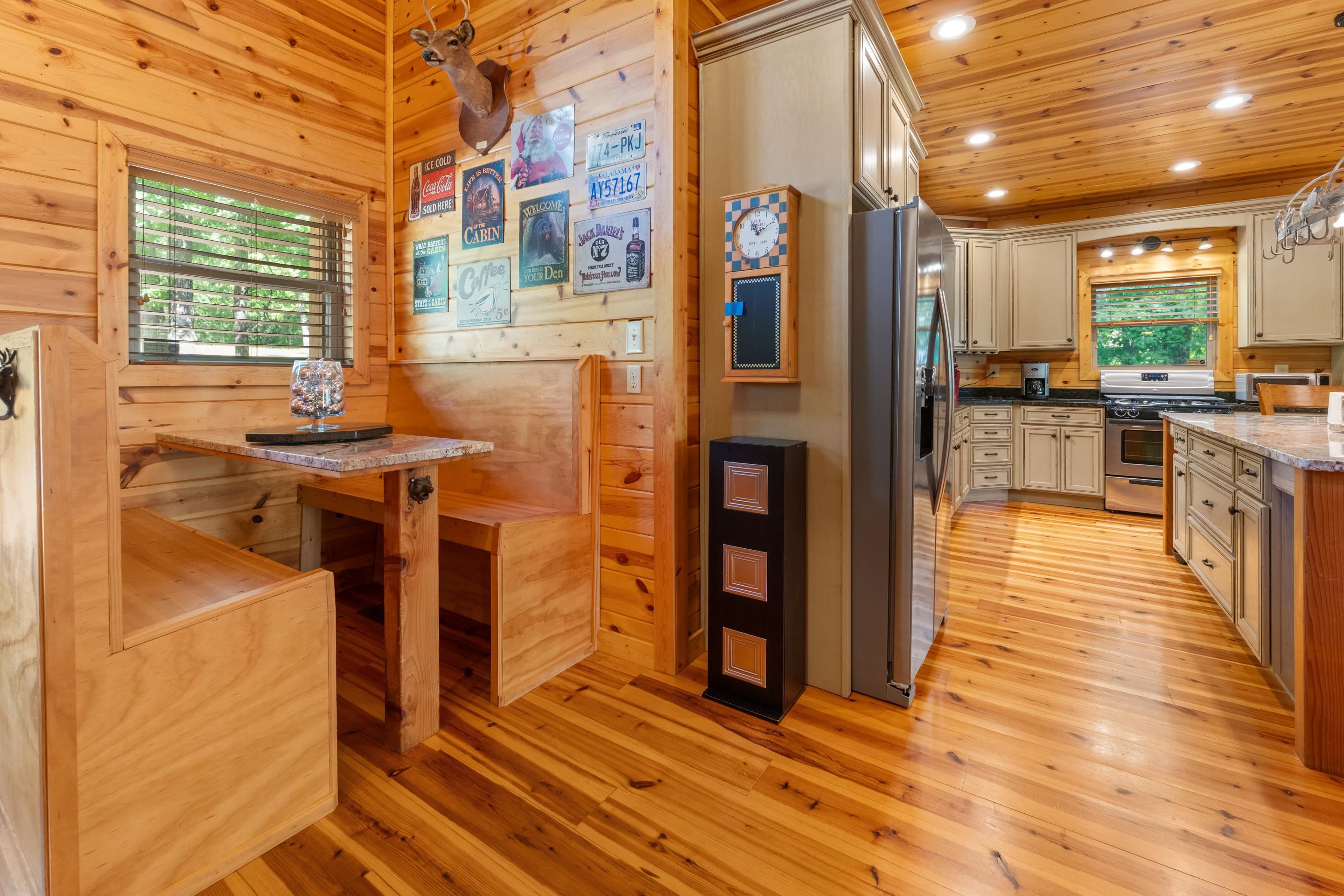 950 Cherry Road Eads, TN 38028 - Photo 7 of 30 Wood-paneled interior featuring a built-in banquette dining area with a granite-style tabletop
