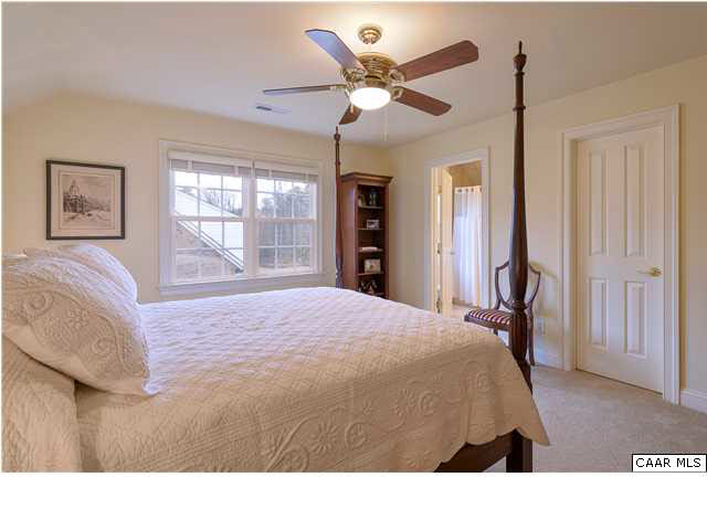 3333 Darby Road, Unit T271 Keswick, VA 22947 - Photo 18 of 32 a bedroom with a bed and a chandelier