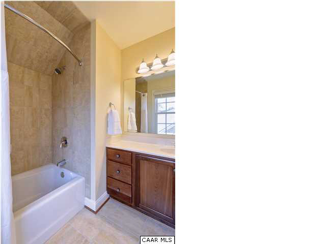 3333 Darby Road, Unit T271 Keswick, VA 22947 - Photo 19 of 32 a bathroom with a tub sink shower and two mirror