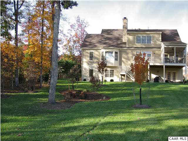 3333 Darby Road, Unit T271 Keswick, VA 22947 - Photo 26 of 32 a view of a big house with a big yard and large trees
