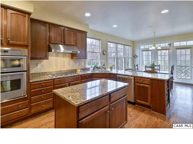 3333 Darby Road, Unit T271 Keswick, VA 22947 - Photo 9 of 32 a kitchen with a stove a sink and a refrigerator