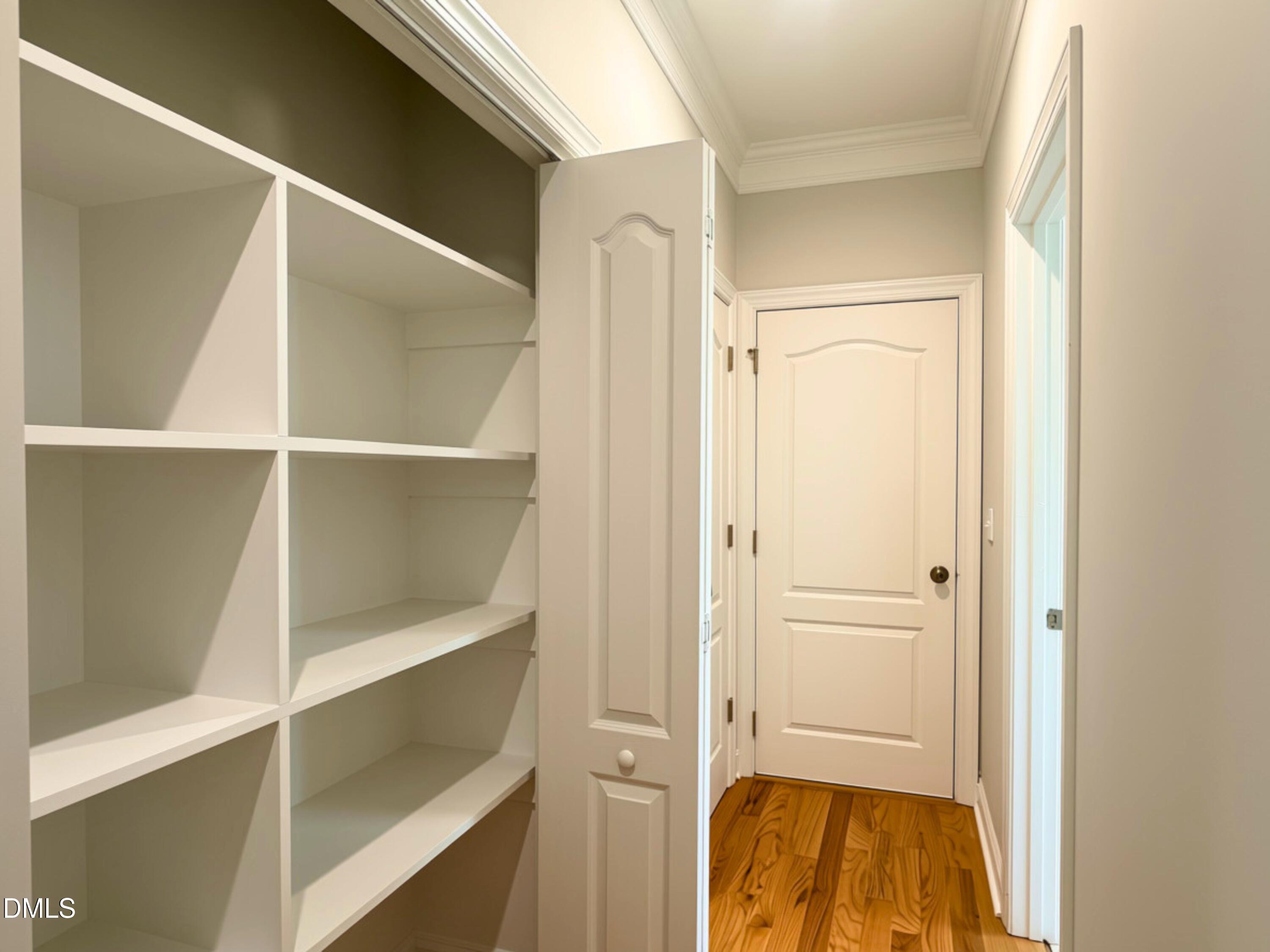 3100 Donlin Drive Wake Forest, NC 27587 - Photo 40 of 67 Built-in shelving, crown molding, wood-finish flooring, and panel doors