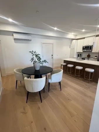 a living room with furniture a rug and a window
