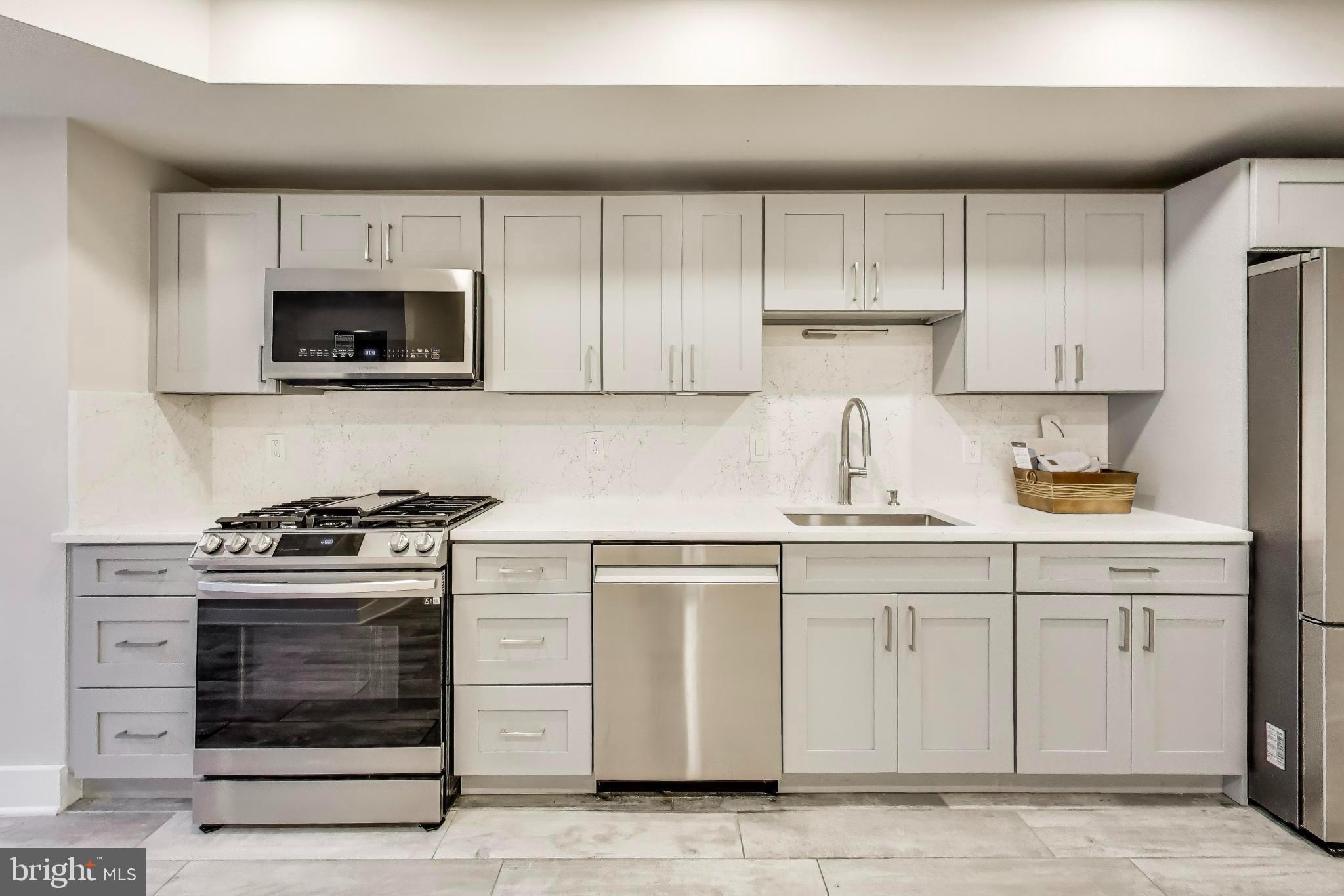 1444 Harvard Street Northwest, Unit 1 Washington, DC 20009 - Photo 10 of 19 Modern kitchen with sleek cabinetry.
