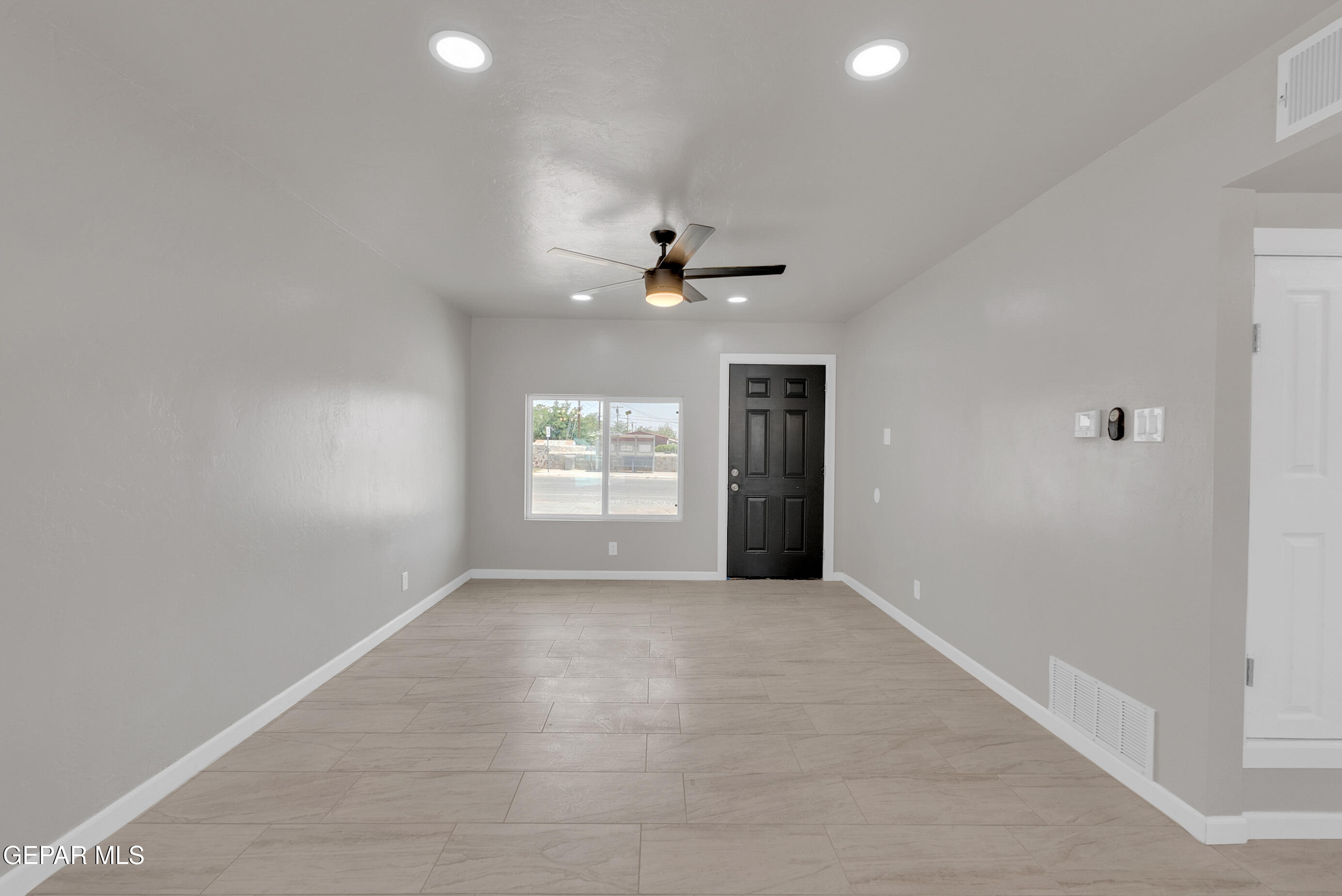 10141 Alcan Street El Paso, TX 79924 - Photo 15 of 49 an empty room with windows and a ceiling fan
