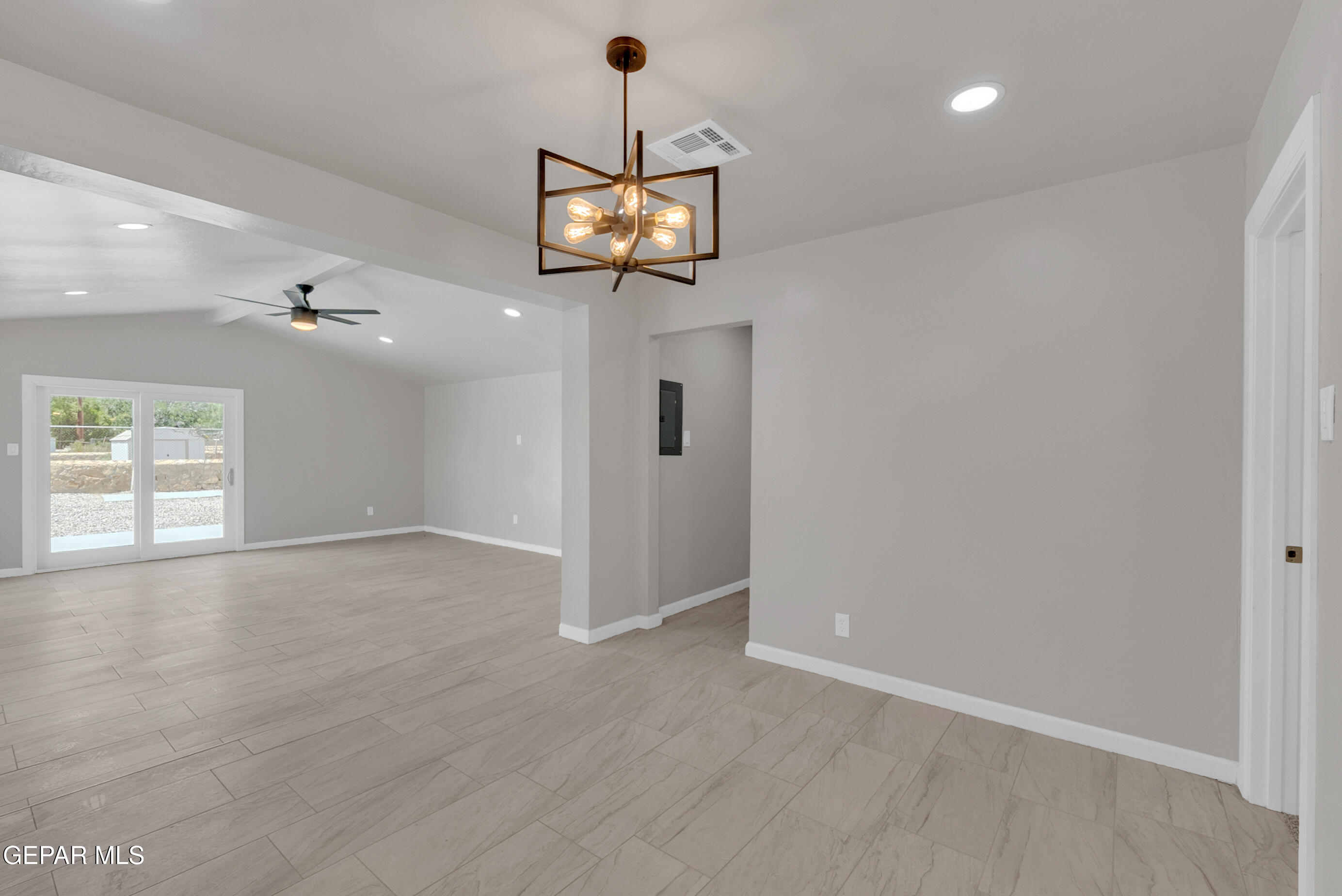 10141 Alcan Street El Paso, TX 79924 - Photo 17 of 49 an empty room with wooden floor ceiling fan and windows