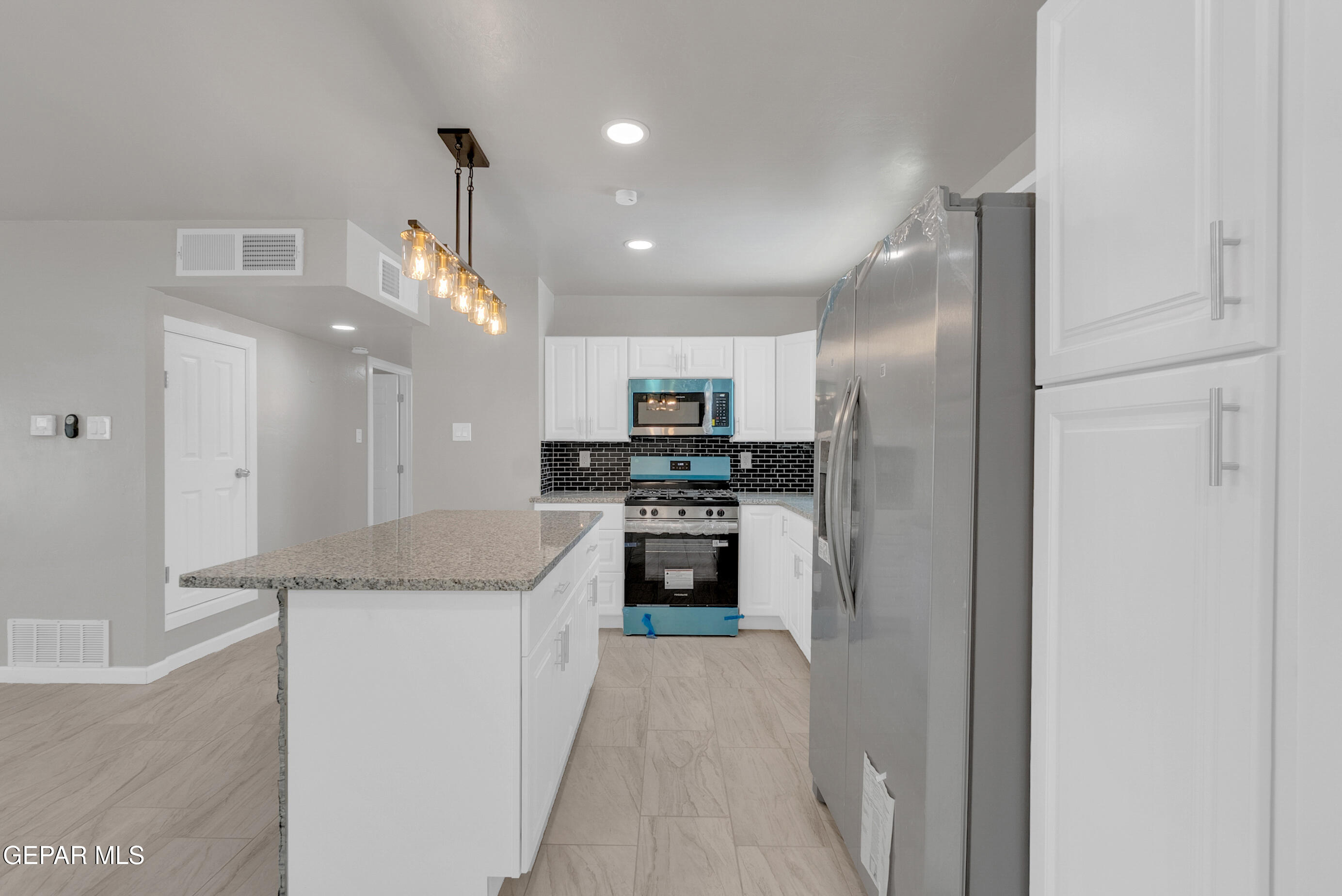 10141 Alcan Street El Paso, TX 79924 - Photo 22 of 49 a kitchen with stainless steel appliances granite countertop a refrigerator a sink and a stove