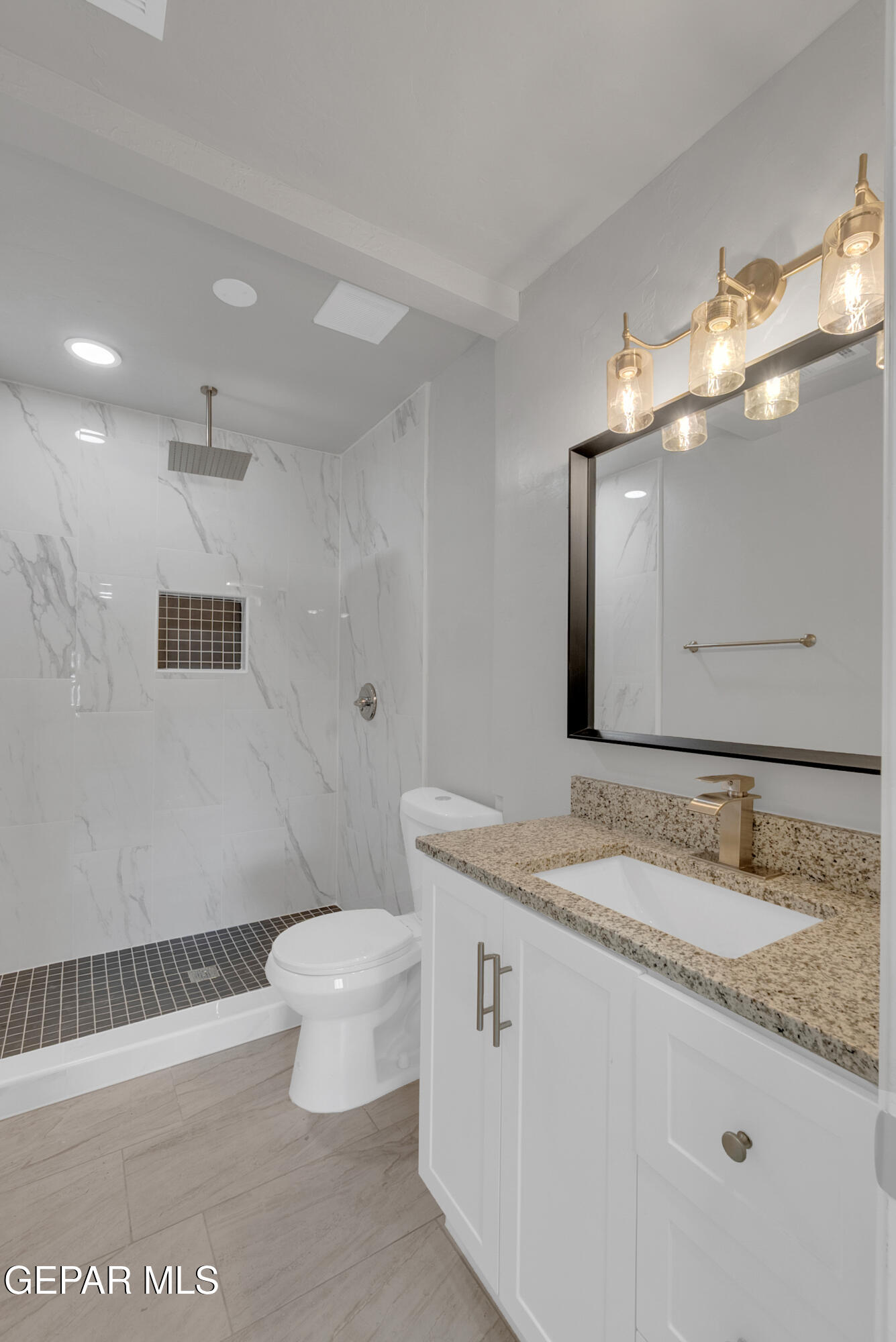 10141 Alcan Street El Paso, TX 79924 - Photo 28 of 49 a bathroom with a granite countertop sink a toilet and a mirror