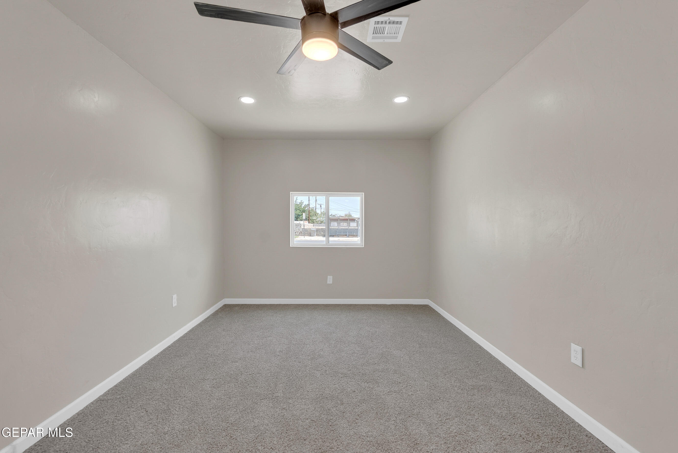 10141 Alcan Street El Paso, TX 79924 - Photo 30 of 49 an empty room with a window and a ceiling fan