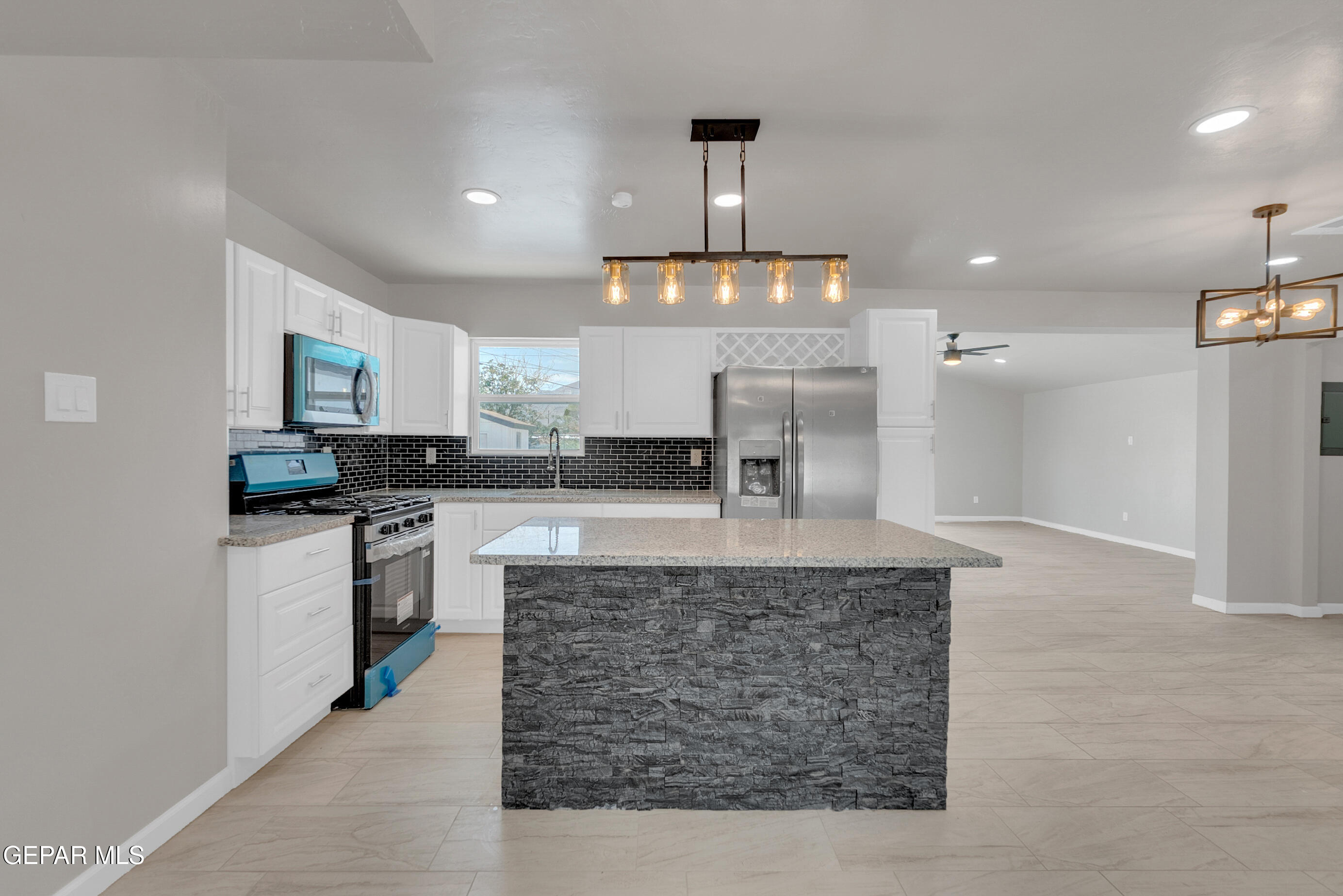 10141 Alcan Street El Paso, TX 79924 - Photo 3 of 49 a large kitchen with granite countertop a stove and a sink