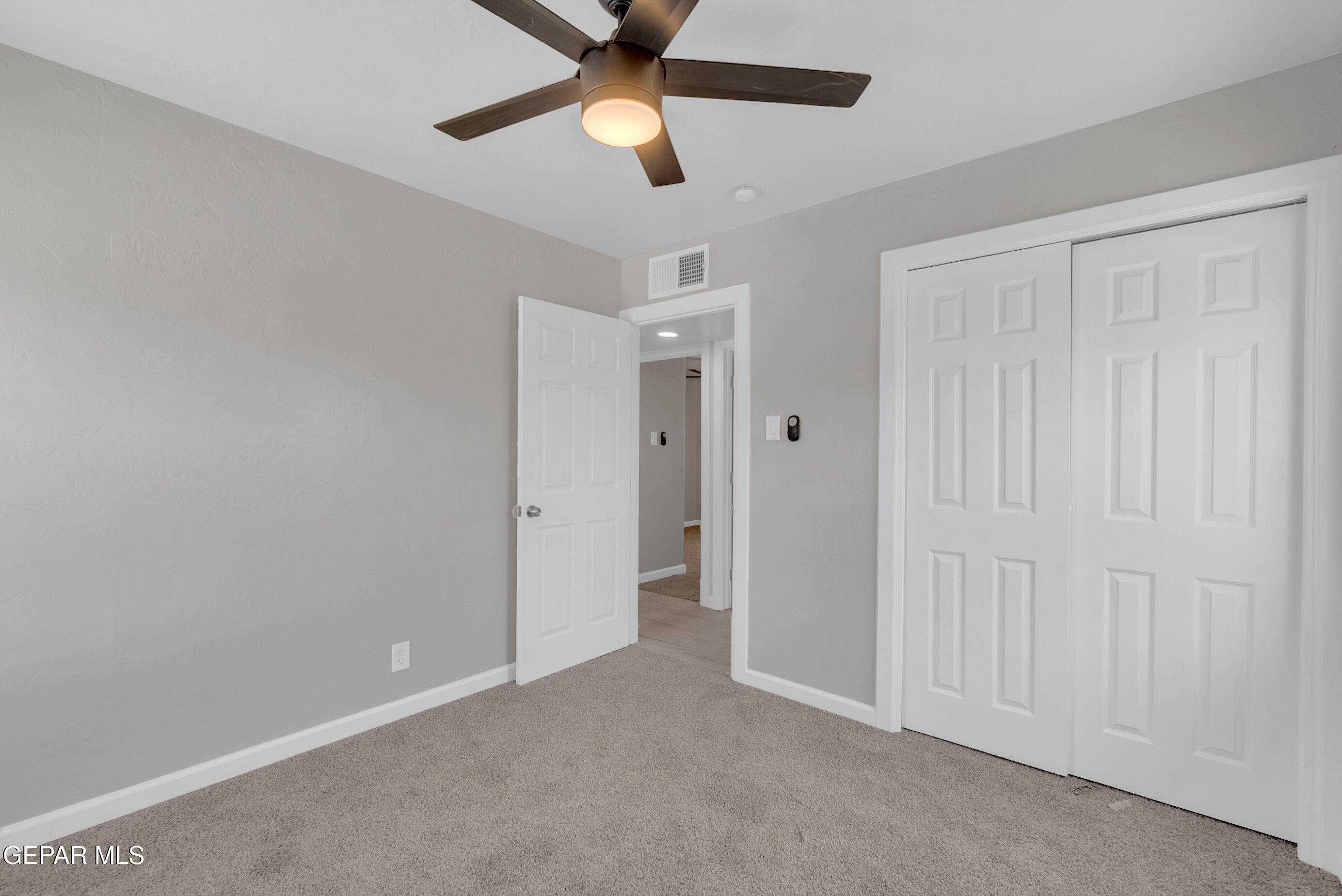 10141 Alcan Street El Paso, TX 79924 - Photo 39 of 49 an empty room with closet and a chandelier fan