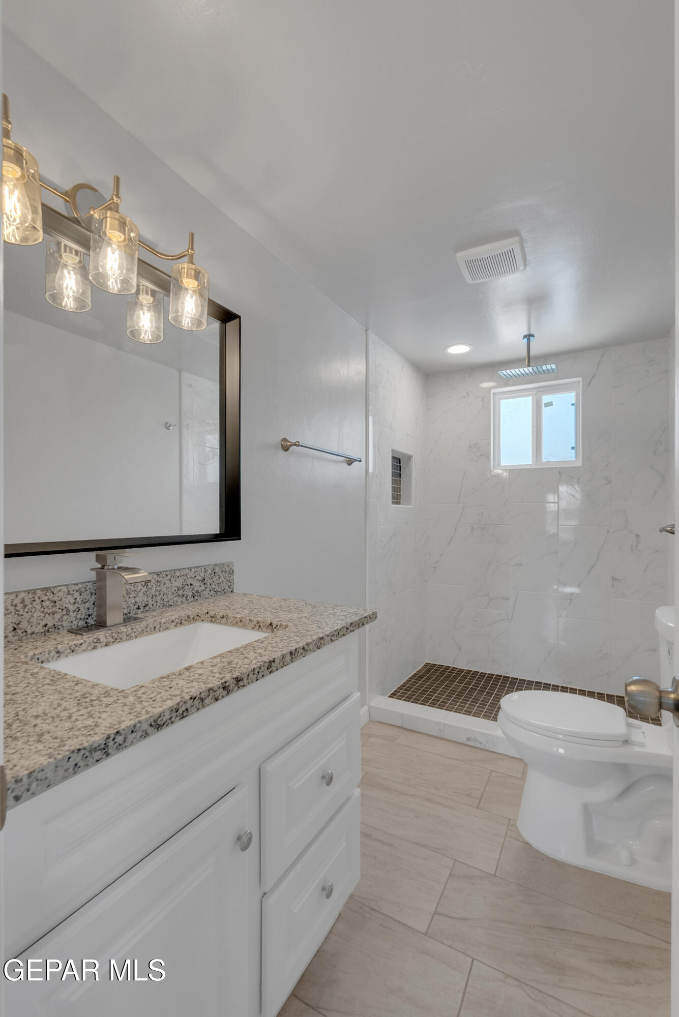 10141 Alcan Street El Paso, TX 79924 - Photo 40 of 49 a spacious bathroom with a granite countertop sink a toilet and a large mirror
