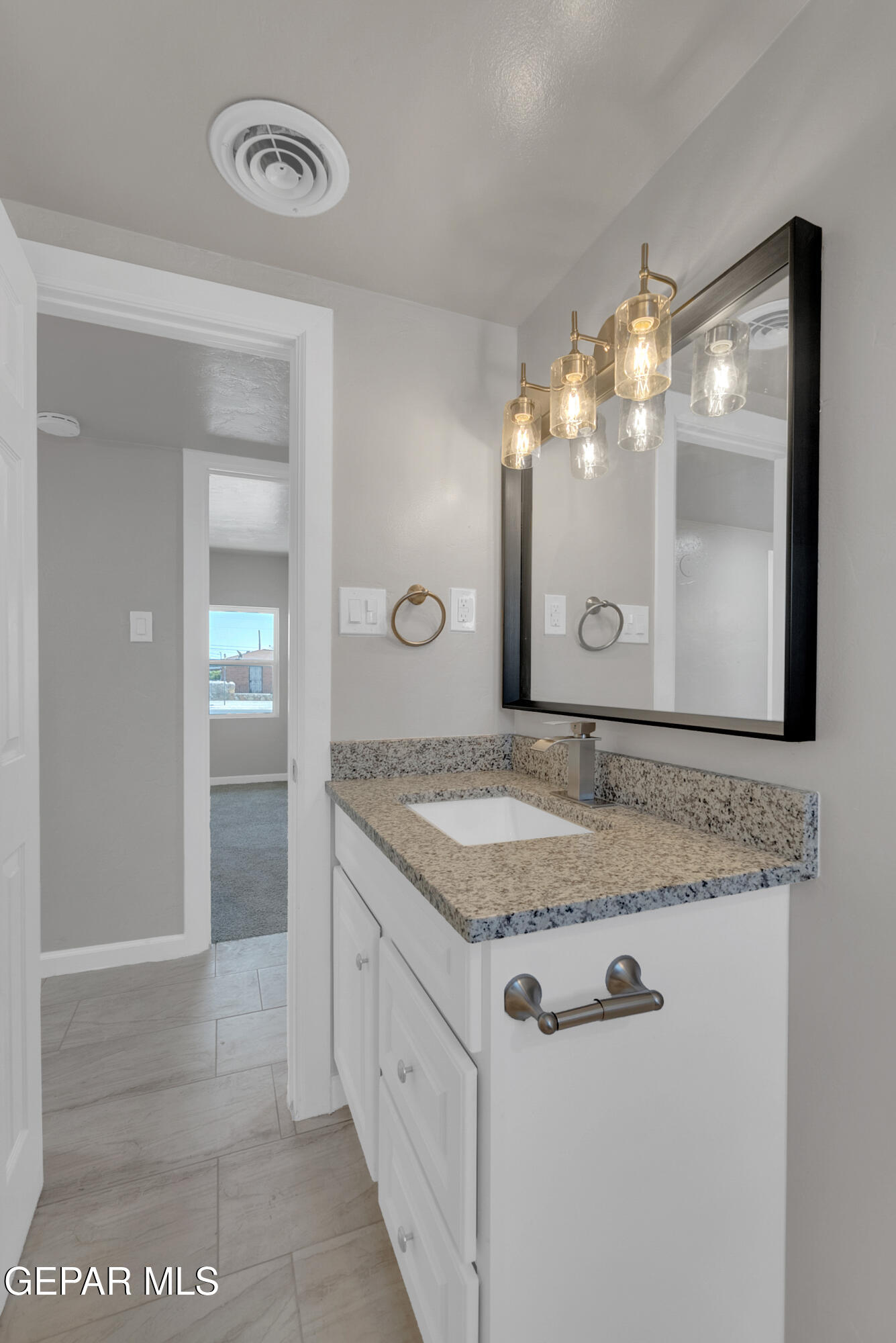 10141 Alcan Street El Paso, TX 79924 - Photo 41 of 49 a bathroom with a granite countertop sink and a mirror