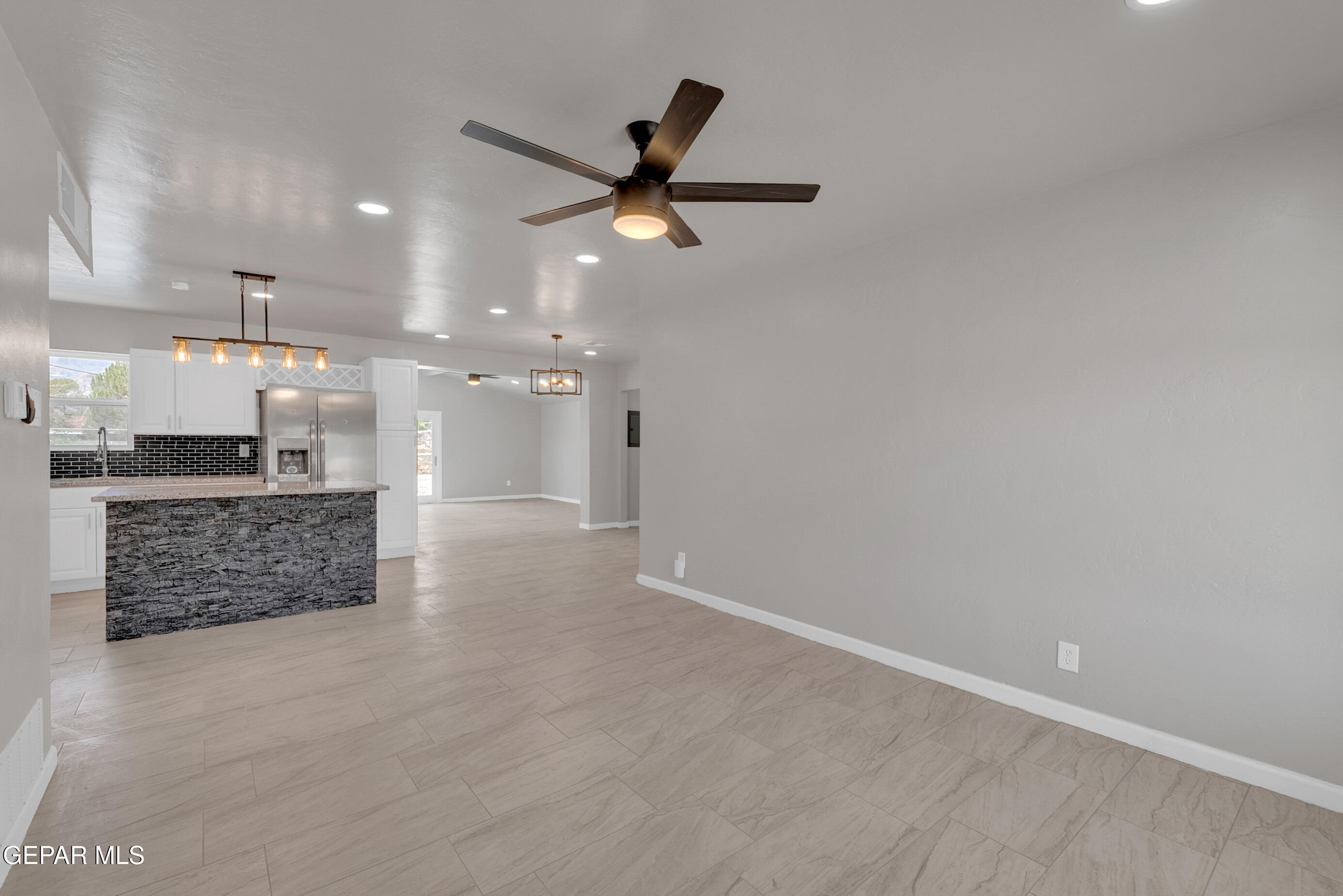 10141 Alcan Street El Paso, TX 79924 - Photo 5 of 49 wooden floor in an empty room with a kitchen
