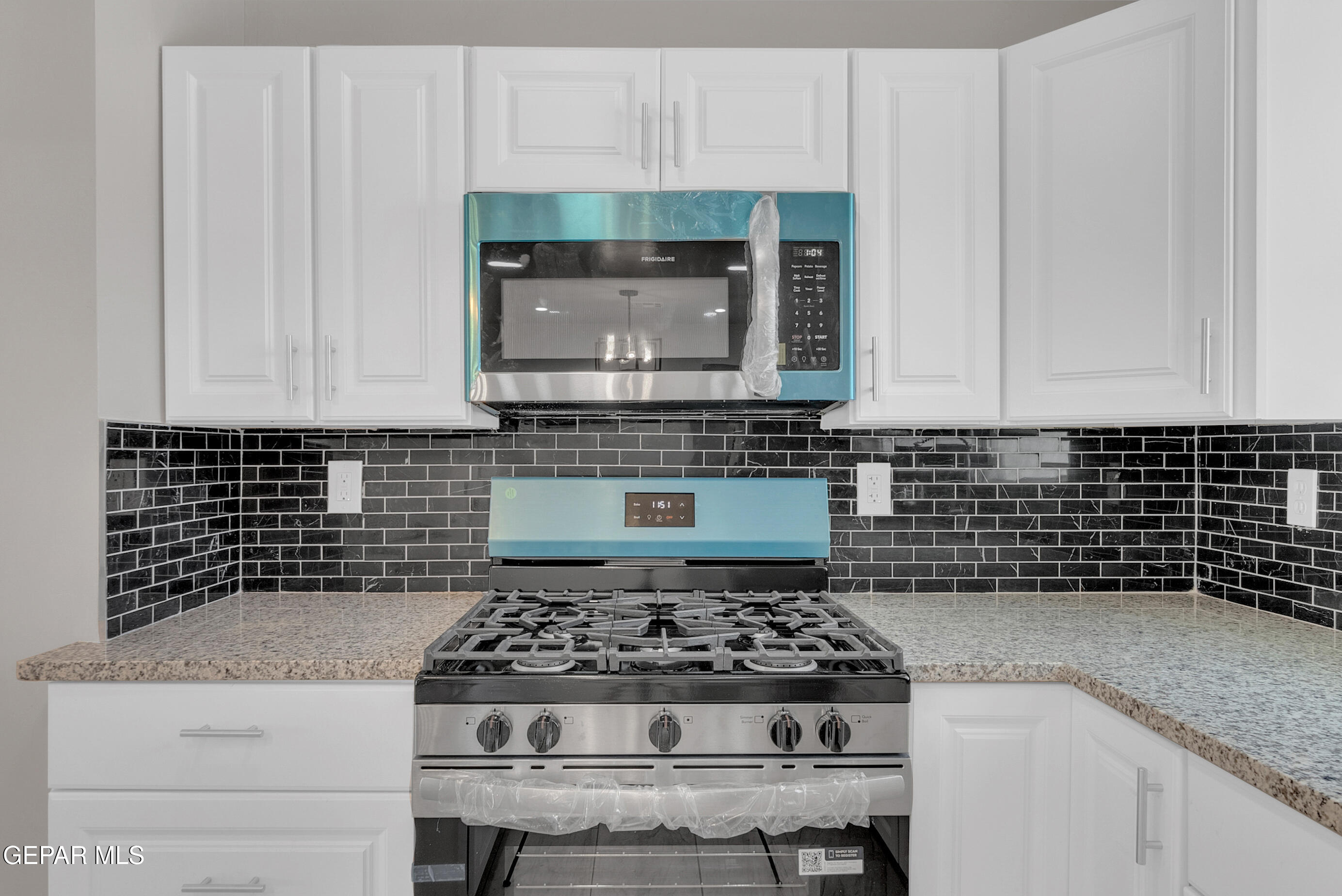 10141 Alcan Street El Paso, TX 79924 - Photo 10 of 49 a kitchen with granite countertop a stove sink and cabinets